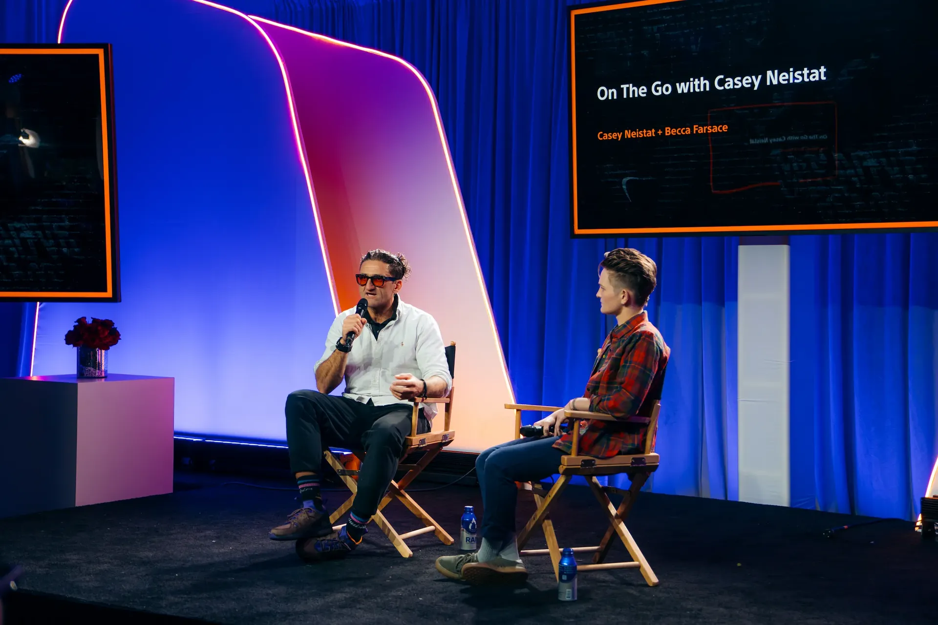 Casey Neistat on stage with microphone during the “On The Go with Casey Neistat” panel at the Sony A1 Mark II event in New York.